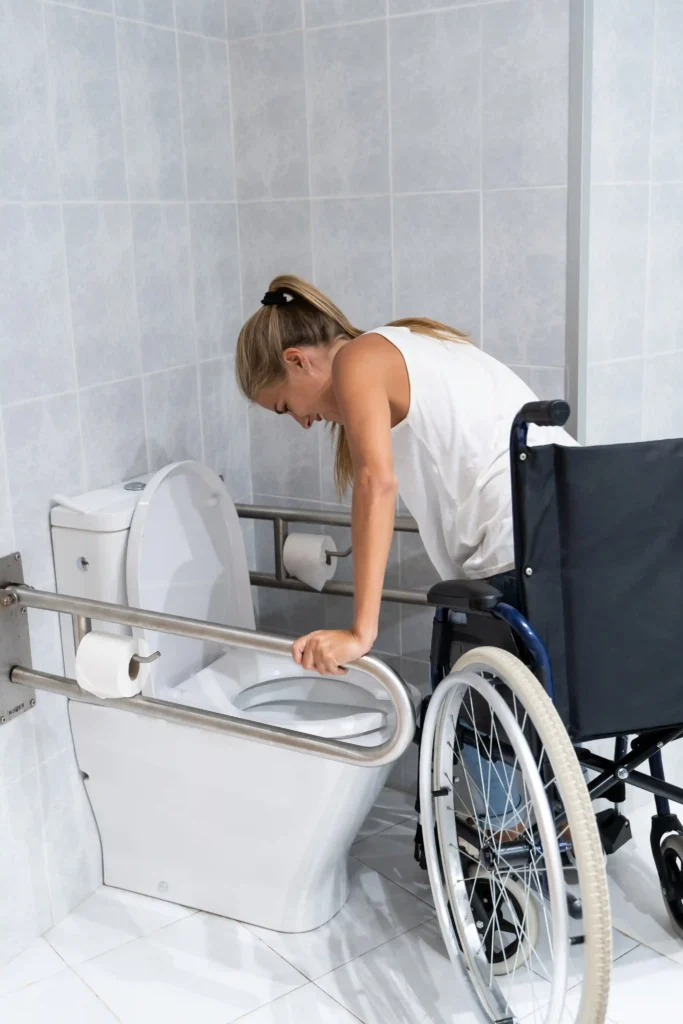 Young woman in a wheelchair using the bathroom accessibility