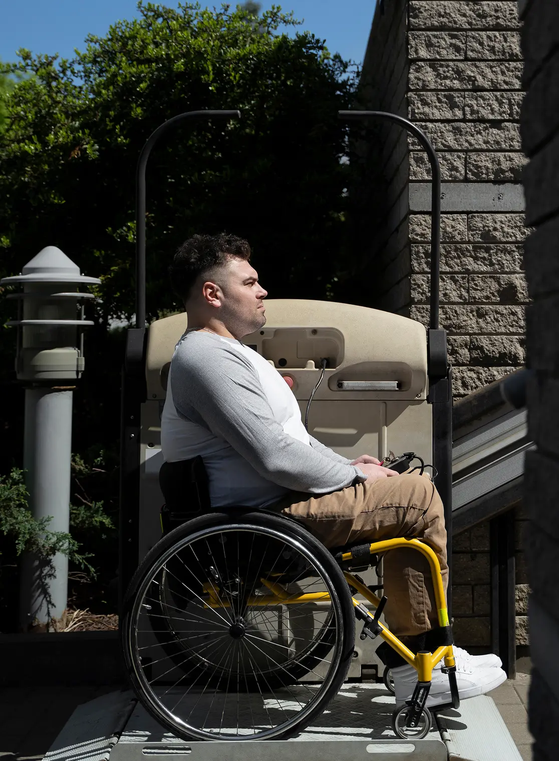 side view of a man in a wheelchair outdoors